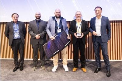 Five men pose for a photo with an award and a small solar panel